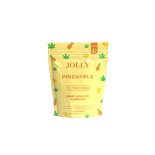 A yellow resealable pouch from Jolly Cannabis labeled Pineapple Gummies 15mg THC, 15mg CBD shows pineapples and hemp leaves, highlights a 1:1 THC:CBD ratio, and displays hemp-derived gummies info on a plain white background.