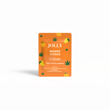 A bright orange pouch labeled Jolly Cannabis Mango Citrus Gummies features mango, citrus, and green hemp leaf graphics. Arizona-made and hemp-derived, each fruit puree gummy contains 15mg THC and 15mg CBD; net weight 42g.