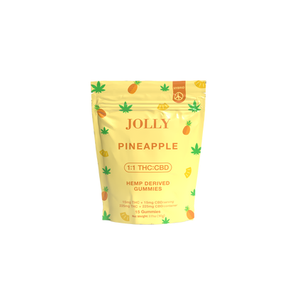 A yellow resealable pouch from Jolly Cannabis labeled Pineapple Gummies 15mg THC, 15mg CBD shows pineapples and hemp leaves, highlights a 1:1 THC:CBD ratio, and displays hemp-derived gummies info on a plain white background.