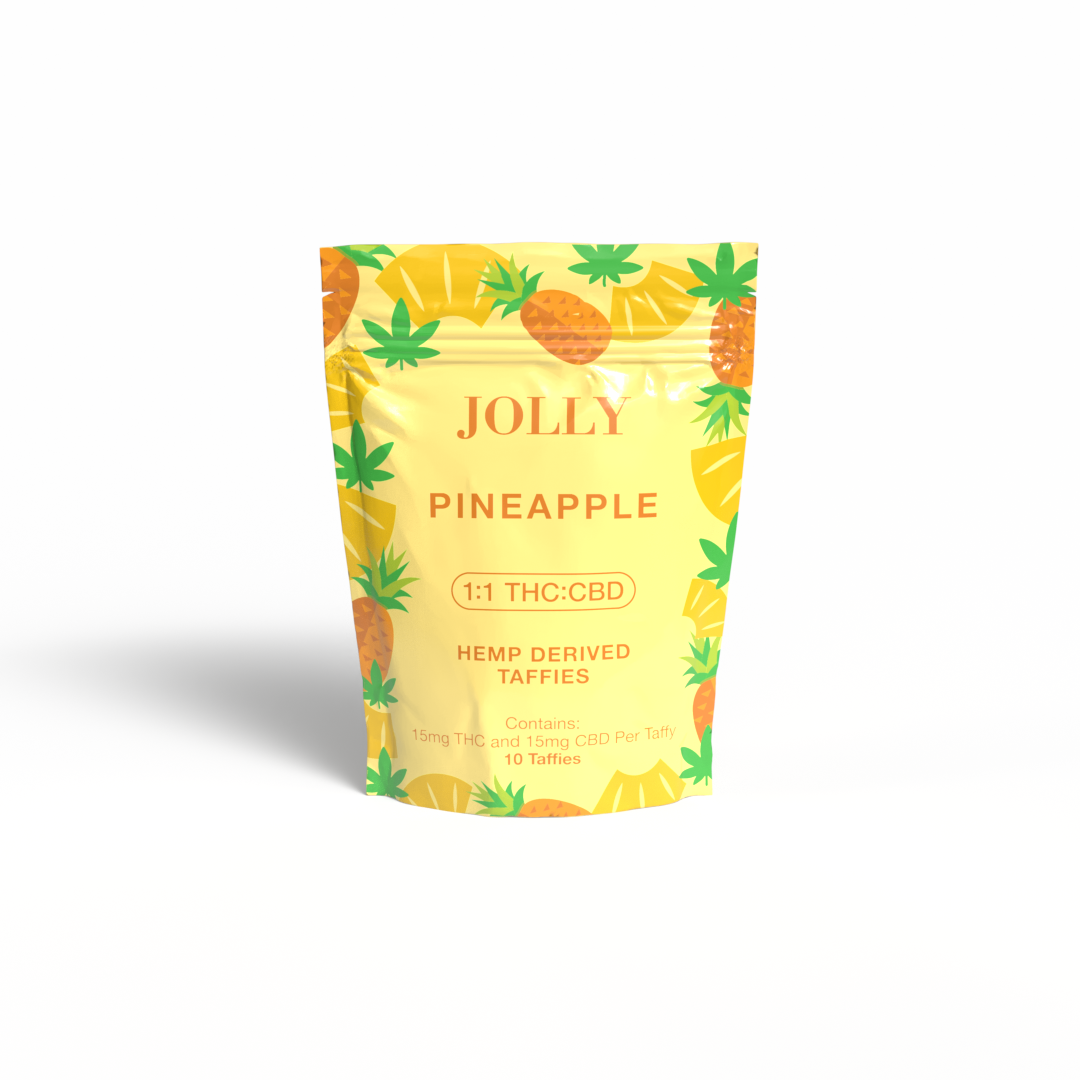 A yellow Jolly Cannabis bag labeled “Pineapple Taffy” features pineapples and green leaves. It contains 10 Arizona-made, hemp-derived soft chews, each with 15mg THC and 15mg CBD, shown on a white background.