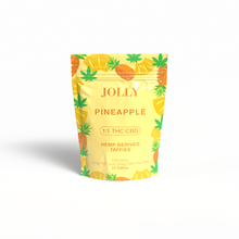 A yellow Jolly Cannabis bag labeled “Pineapple Taffy” features pineapples and green leaves. It contains 10 Arizona-made, hemp-derived soft chews, each with 15mg THC and 15mg CBD, shown on a white background.